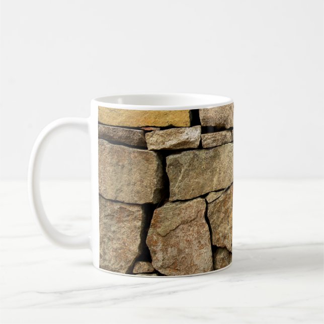 A stone wall made of cobblestones background textu coffee mug (Left)