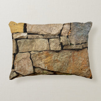 A stone wall made of cobblestones background textu decorative cushion