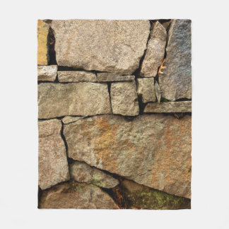 A stone wall made of cobblestones background textu fleece blanket