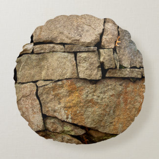 A stone wall made of cobblestones background textu round cushion