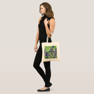 A stylish green and purple patterned image with a tote bag