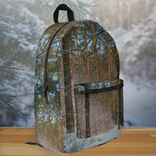 A sunny winter day in the pine forest printed backpack