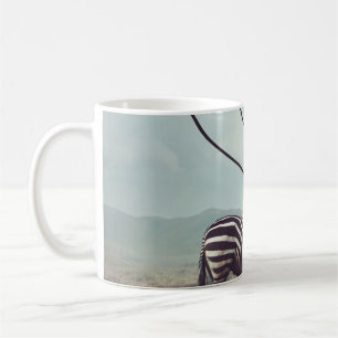 A surreal image of a zebra and two of its black st coffee mug