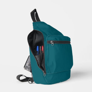 A teal blue textured background fills the image sling bag