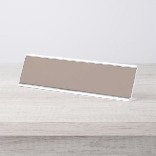 A textured background of various shades of brown, desk name plate