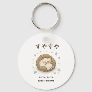 A tiny hedgehog enjoying a peaceful nap key ring