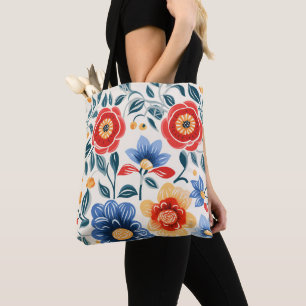 A tote bag with black handles features a colourful