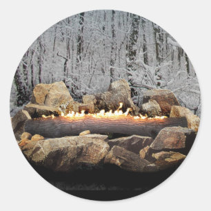 A Tranquil Burning Yule Log in a Snowy Forest Classic Round Sticker
