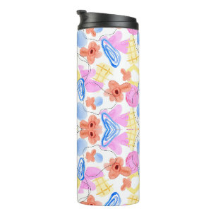 A travel mug with a colourful, abstract symmetrica
