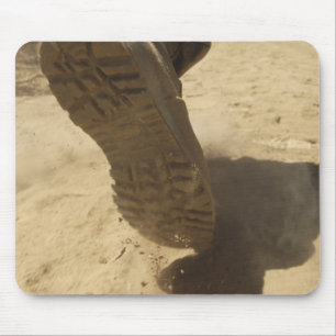 A US soldier walks along a dirt path Mouse Pad