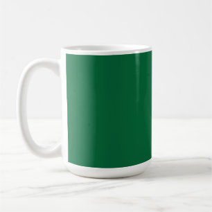 A vibrant green leaf with distinct veins is illumi coffee mug