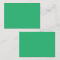 A vibrant green leaf with prominent veins and a de