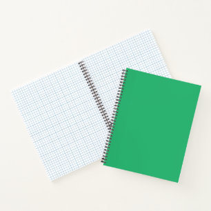A vibrant green leaf with prominent veins and a de notebook