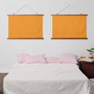 A vivid orange square surrounded by a white border hanging tapestry