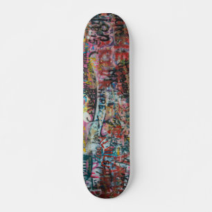 a wall full of graffiti skateboard