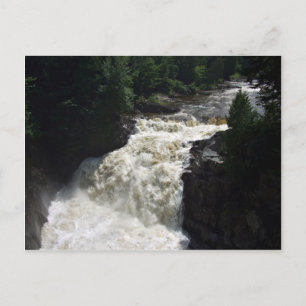 A waterfall with trees and rocks postcard