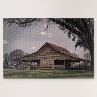 A weathered wooden barn surrounded by lush grass jigsaw puzzle