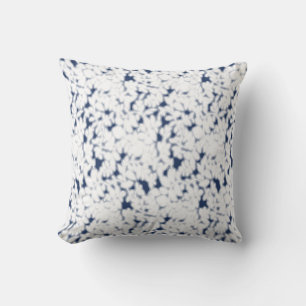 a white and blue background with a pattern cushion