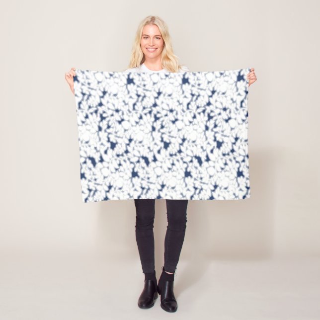 a white and blue background with a pattern fleece blanket (In Situ)