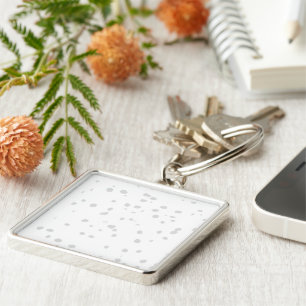 a white background with a lot of small dots key ring