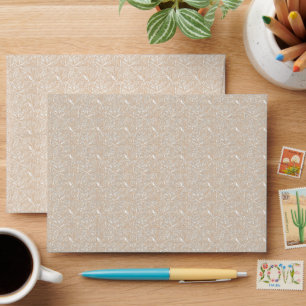 a white background with a pattern of leaves envelope