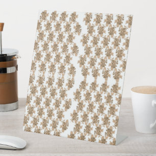 a white background with brown flowers on it pedestal sign