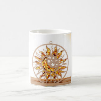 a white mug with an image of sun and moon