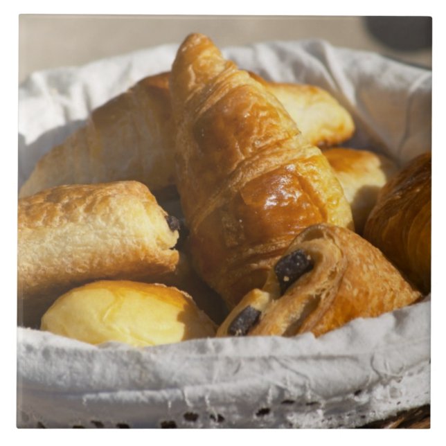A wicker breakfast basket with croissants, and ceramic tile (Front)