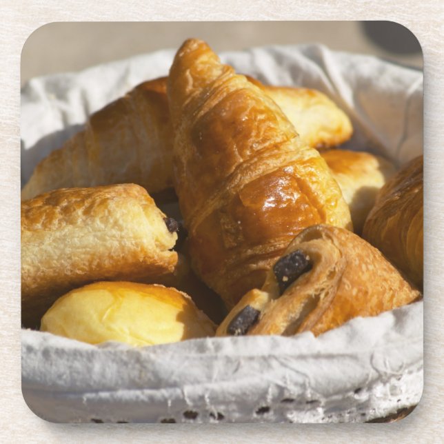 A wicker breakfast basket with croissants, and coaster (Front)