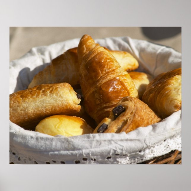 A wicker breakfast basket with croissants, and poster (Front)