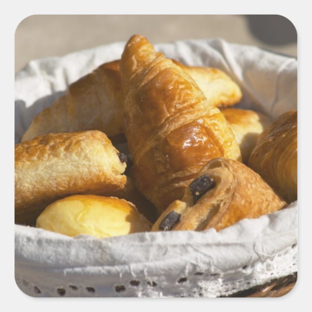 A wicker breakfast basket with croissants, and square sticker (Front)