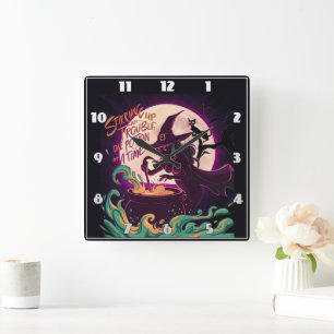 A witch brewing potions under a full moon square wall clock