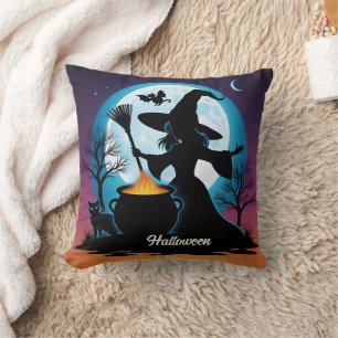 A witch brews up magic under a full moon cushion
