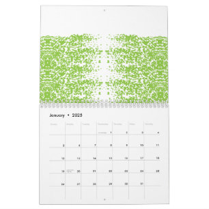 A woman wearing a grey sweater and glasses sits by calendar