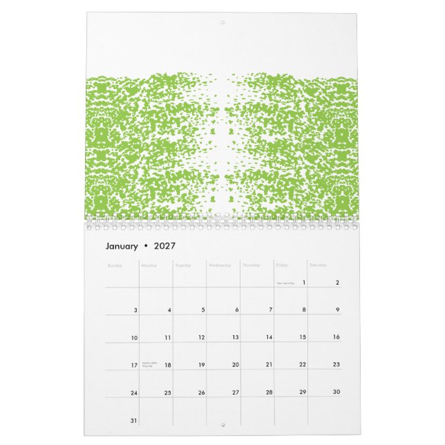 A woman wearing a grey sweater and glasses sits by calendar (Jan 2027)