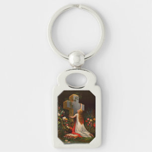 A woman with a cross is praying key ring