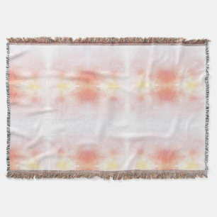 A woven throw blanket features a delicate gradient