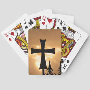 A Wrought-iron Cross on a Fence Playing Cards