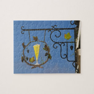A wrought iron sign that illustrates the theme jigsaw puzzle