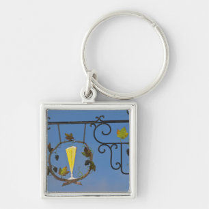 A wrought iron sign that illustrates the theme key ring