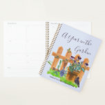 A Year in the Garden Gardener's Planner<br><div class="desc">Personalised gardening planner with any start date. The cover is light blue with elegant hand lettered script typography which reads "A Year in the Garden" with a gorgeous watercolor illustration of a country cottage garden. It features a picket fence and plant pot of pansy flowers, a grass lawn, blackbird, butterfly...</div>