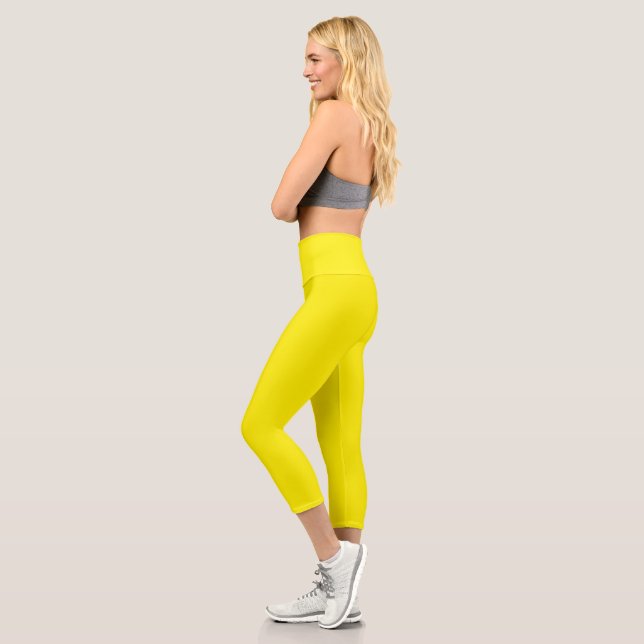 a yellow background with a black border capri leggings (Left)