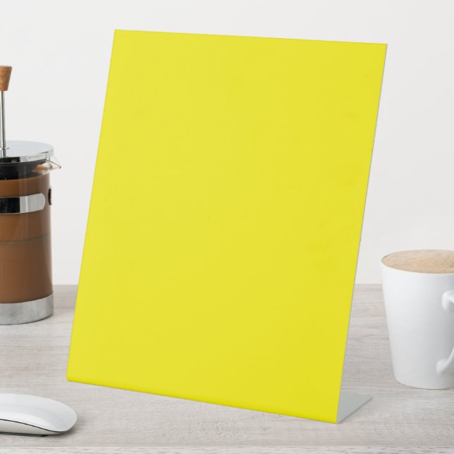 a yellow background with a black border pedestal sign (In SItu)