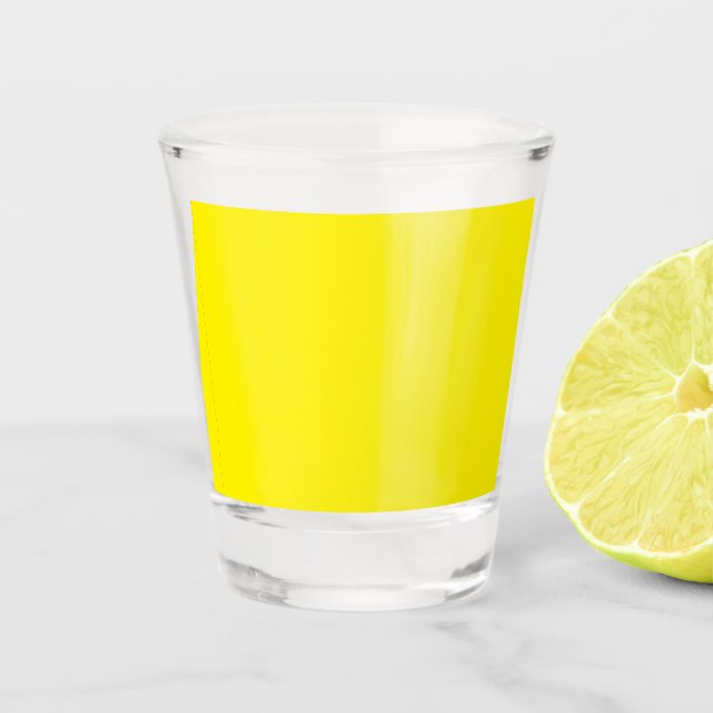 a yellow background with a black border shot glass (Front)