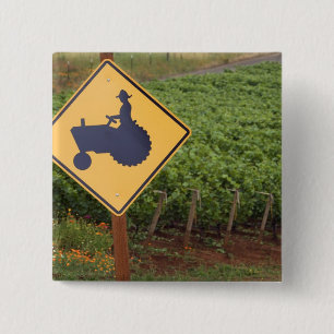 A yellow tractor crossing sign in the vineyard 15 cm square badge