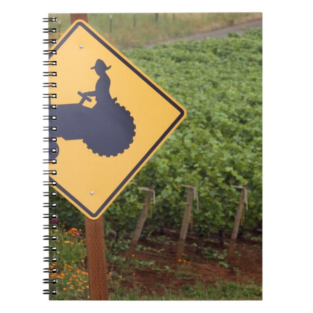A yellow tractor crossing sign in the vineyard notebook (Front)