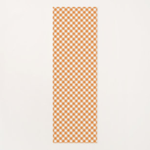 A yoga mat with an orange and white chequered
