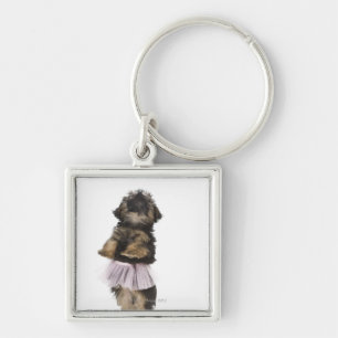 A Yorkie-poo puppy in a tutu on her hind legs. Key Ring