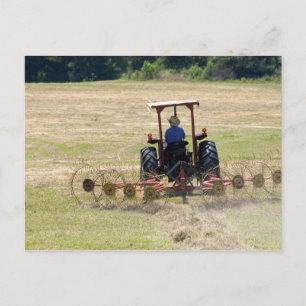 A young boy driving a tractor harvesting postcard