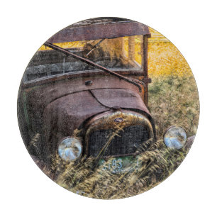 Abandoned old car in tall grass cutting board